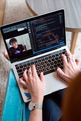 Software Engineer Updating Code with Stakeholder online